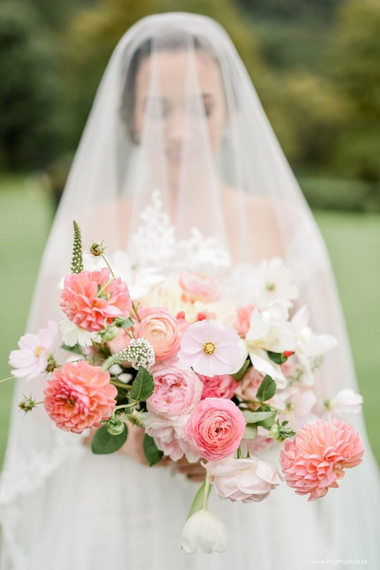 veiled-bride-with-blush-and-coral-bouquet