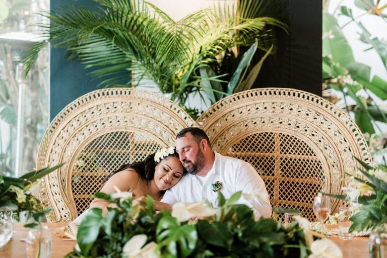 tropical-destination-wedding-bride-and-groom-peacock-chairs