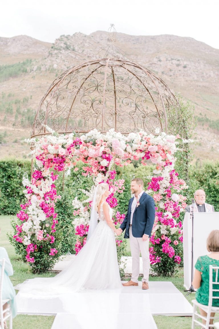 elaborate pink floral ceremony arch