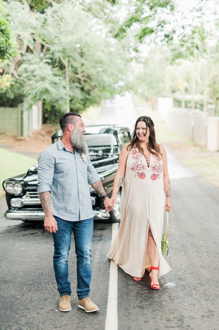 bride and groom with vintage car