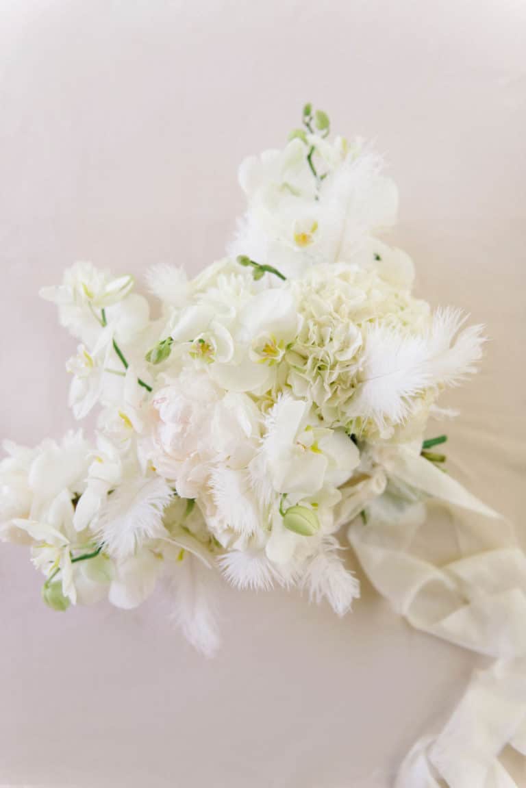 white floral and feather bridal bouquet