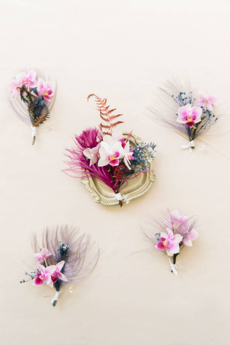 pink floral and feather boutonnieres